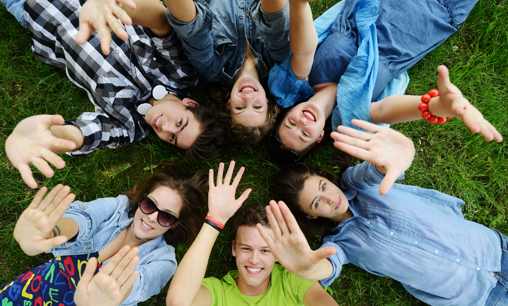 Group of friends lying on meadow